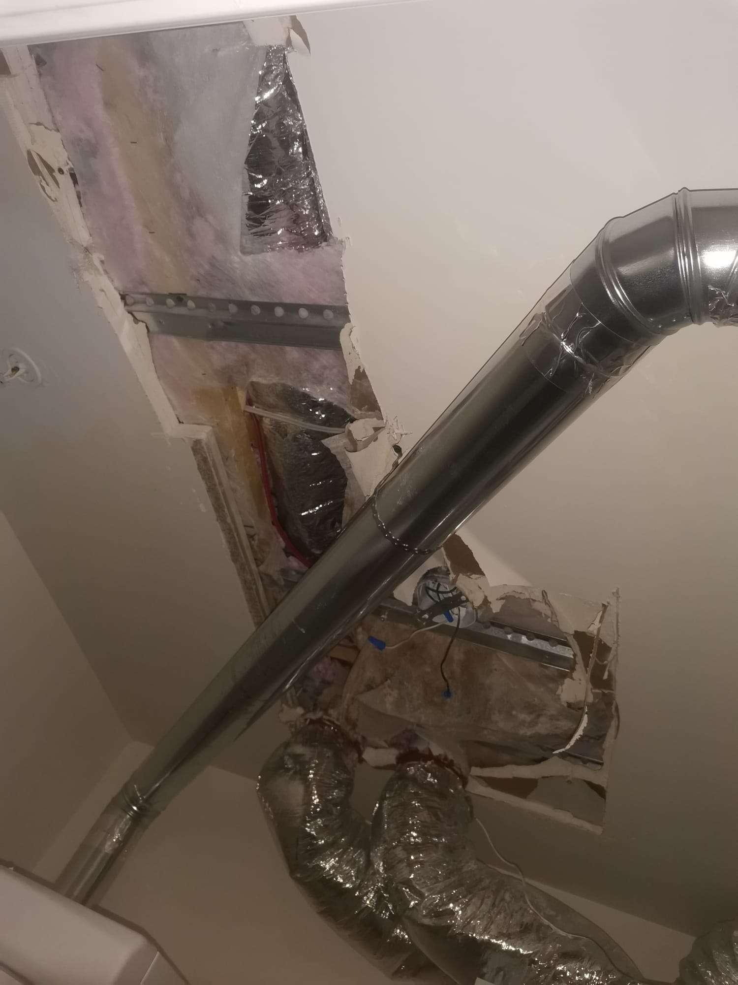 Ceiling opened around ductwork before drywall repair